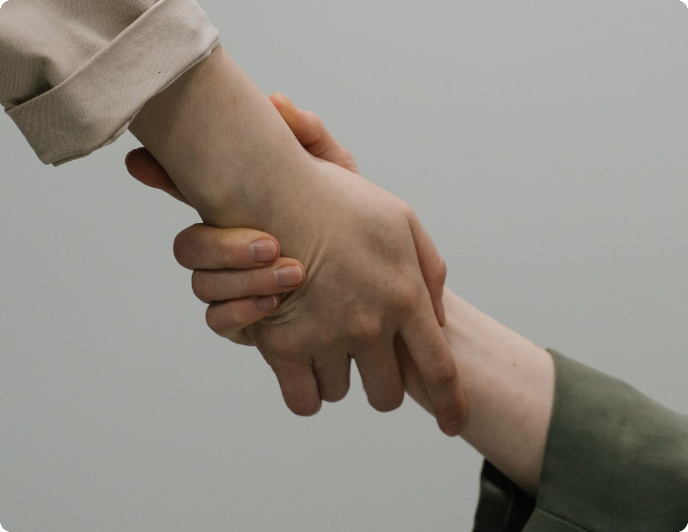 Two people holding hands in support